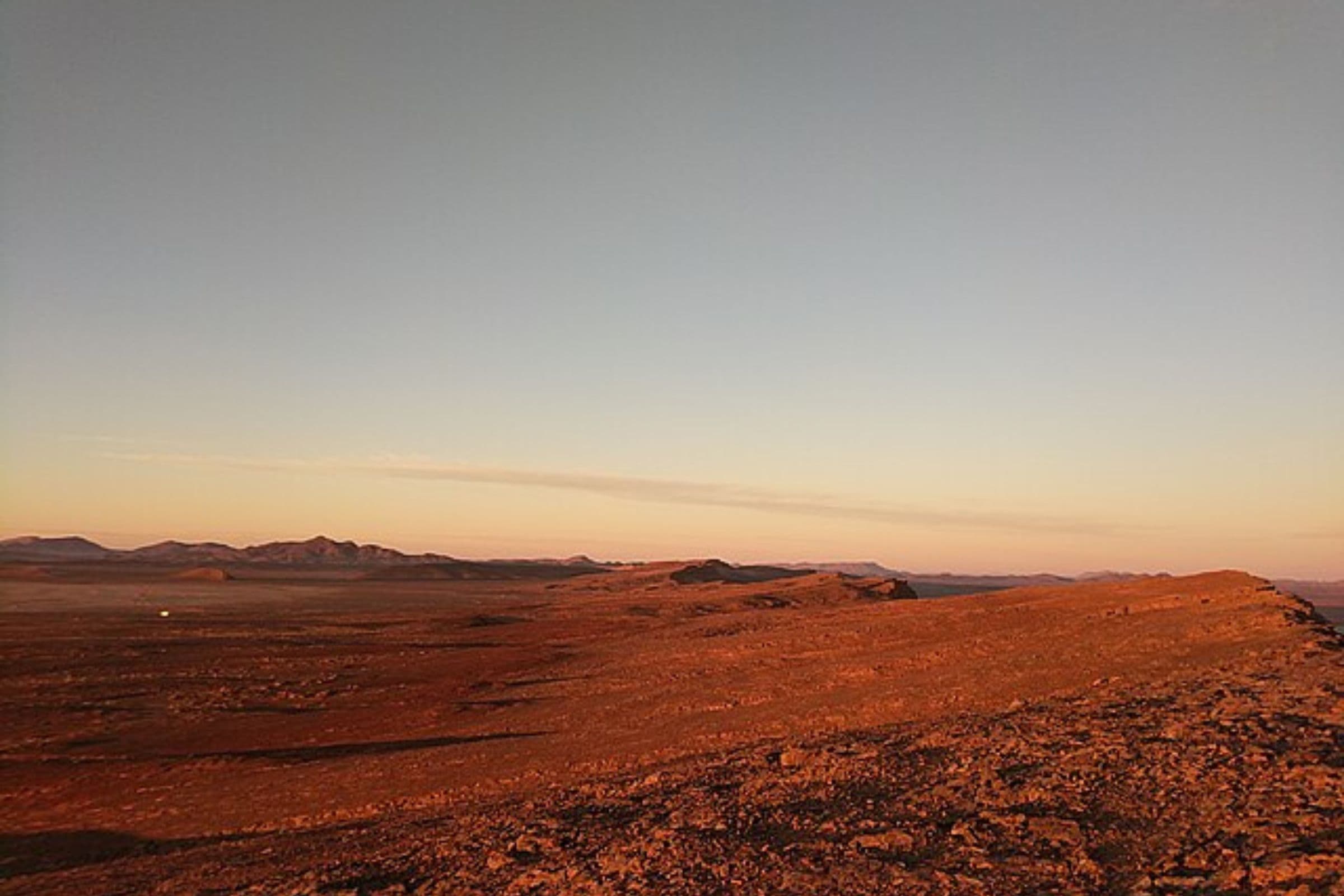 Dromadaire dans les dunes au coucher du soleil